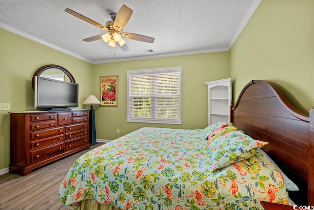 bedroom with ceiling fan, light wood-type flooring, and ornamental molding