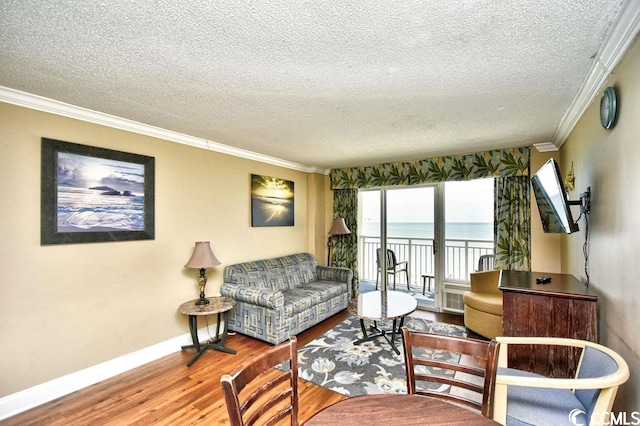 living room featuring ornamental molding, a textured ceiling, and hardwood / wood-style flooring