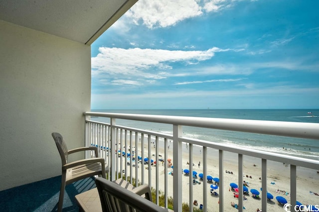 balcony featuring a beach view and a water view