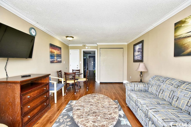 living room featuring wood-type flooring, crown molding, and a textured ceiling