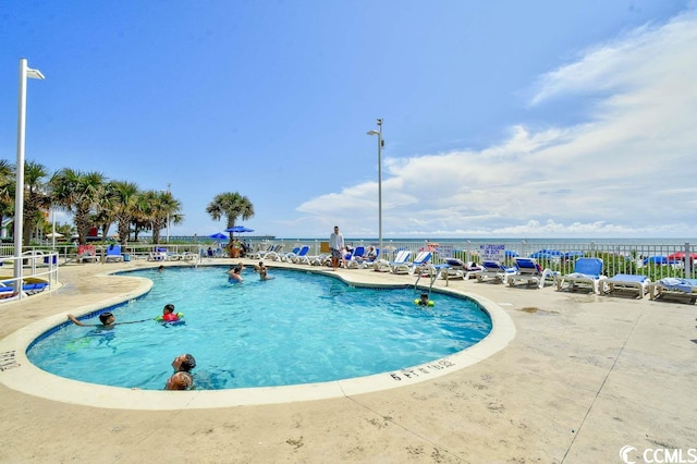 view of pool featuring a water view