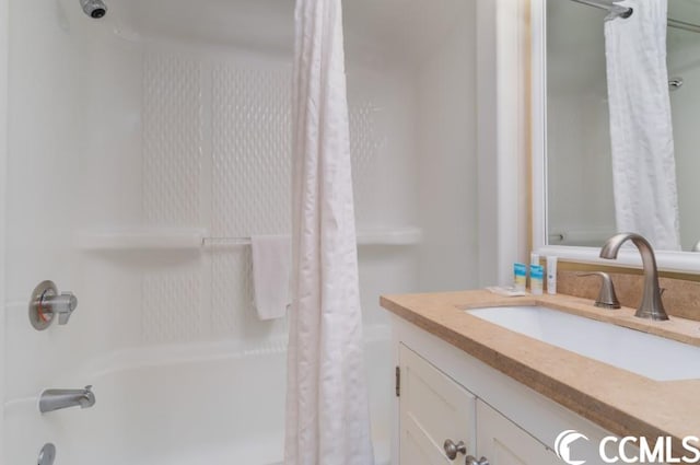 bathroom featuring shower / bathtub combination with curtain and vanity