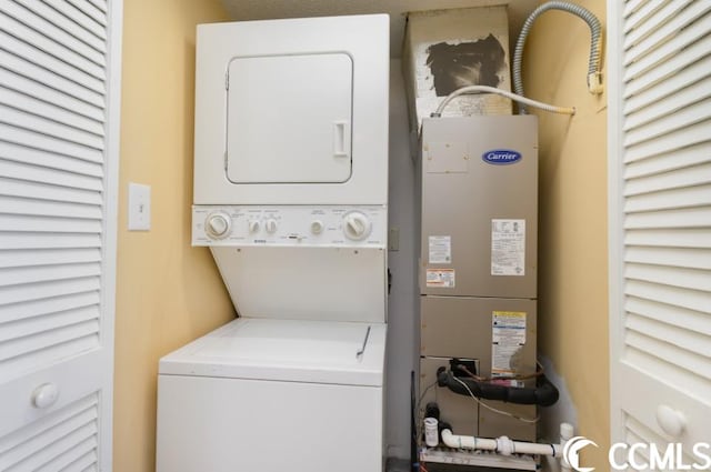 laundry area featuring stacked washer / drying machine