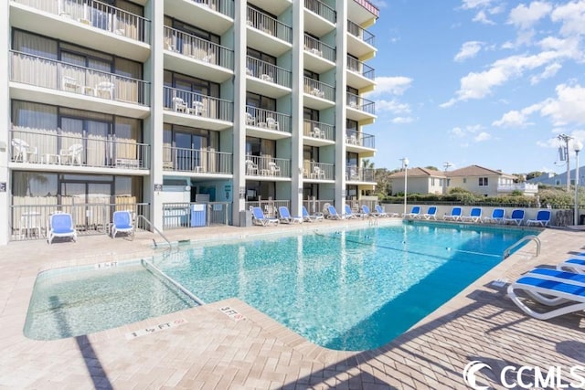 view of swimming pool with a patio area