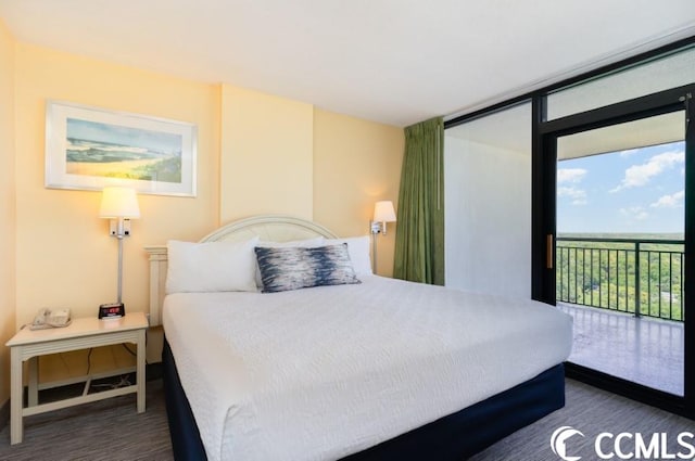 bedroom featuring access to exterior and dark wood-type flooring