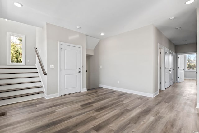 interior space featuring hardwood / wood-style flooring and vaulted ceiling