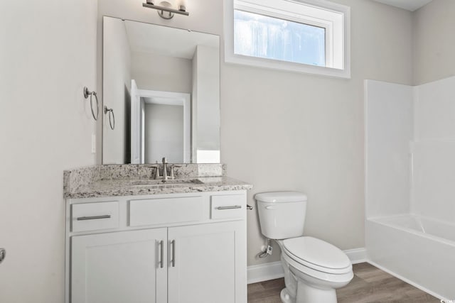 full bathroom featuring vanity, toilet,  shower combination, and hardwood / wood-style floors