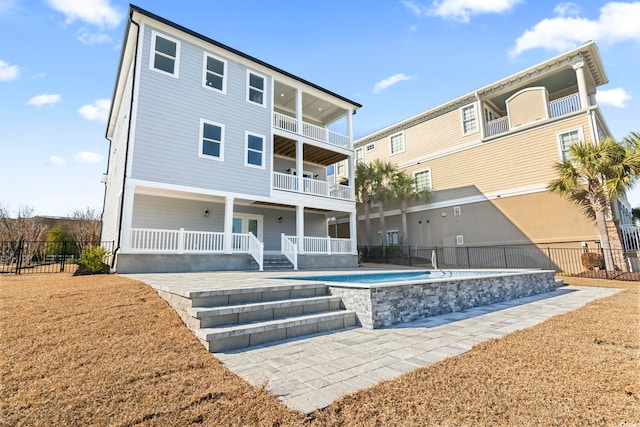 back of property featuring a balcony