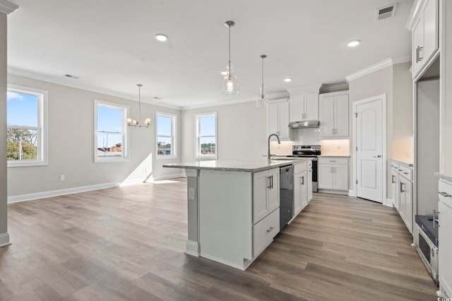 kitchen featuring white cabinetry, sink, a kitchen island with sink, and hanging light fixtures