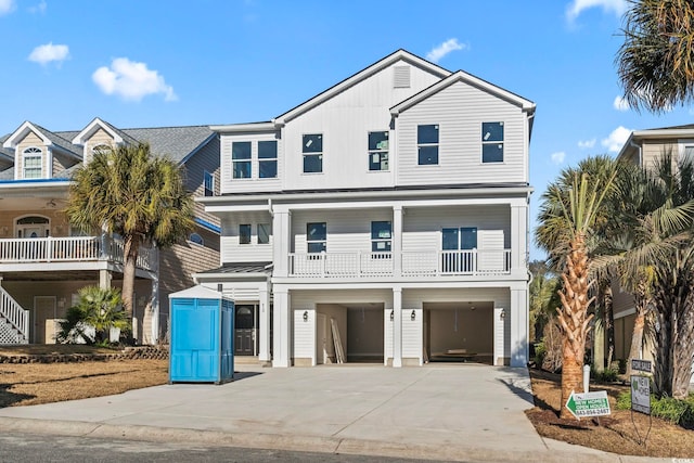 coastal inspired home with a garage and concrete driveway