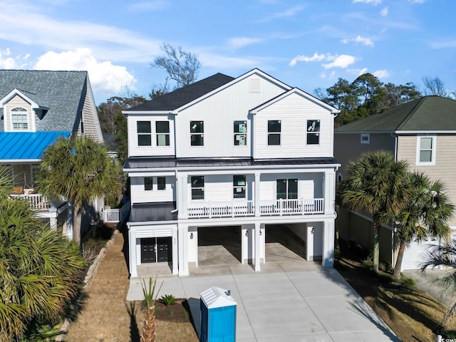 beach home featuring a garage, a balcony, and a carport