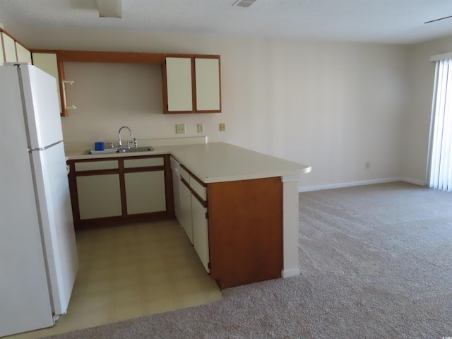 510 Fairwood Lakes Dr Unit 16M, Myrtle Beach, SC 29588 - kitchen featuring white fridge, sink, white cabinets, light colored carpet, and kitchen peninsula