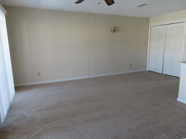 510 Fairwood Lakes Dr Unit 16M, Myrtle Beach, SC 29588 - unfurnished bedroom featuring ceiling fan, a textured ceiling, a closet, and light carpet