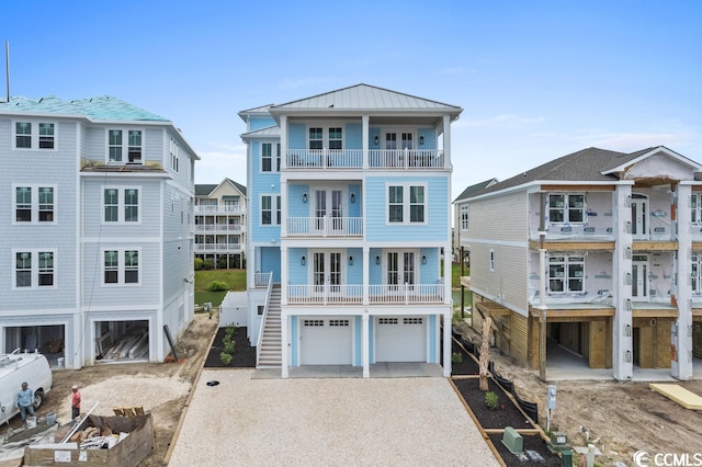 coastal inspired home with a balcony and a garage