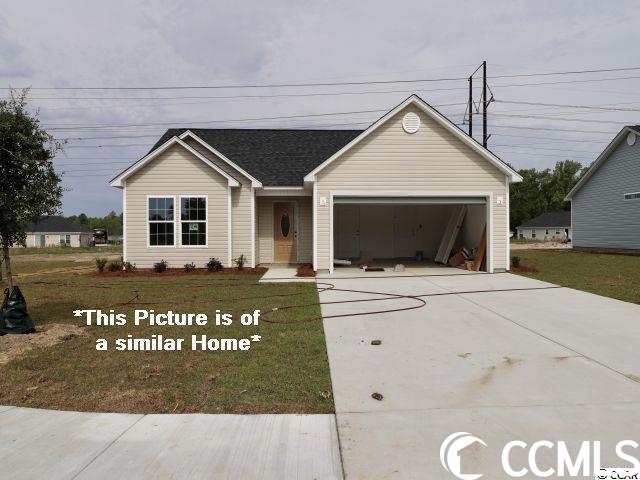 ranch-style home featuring a garage and a front yard