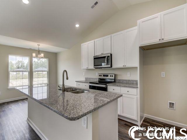 kitchen with white cabinets, sink, a kitchen island with sink, appliances with stainless steel finishes, and dark wood-type flooring