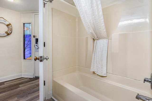 bathroom featuring shower / bathtub combination with curtain and hardwood / wood-style flooring