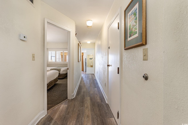 hallway with dark wood-type flooring