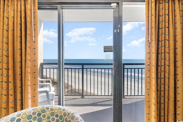 interior space featuring a water view and a view of the beach