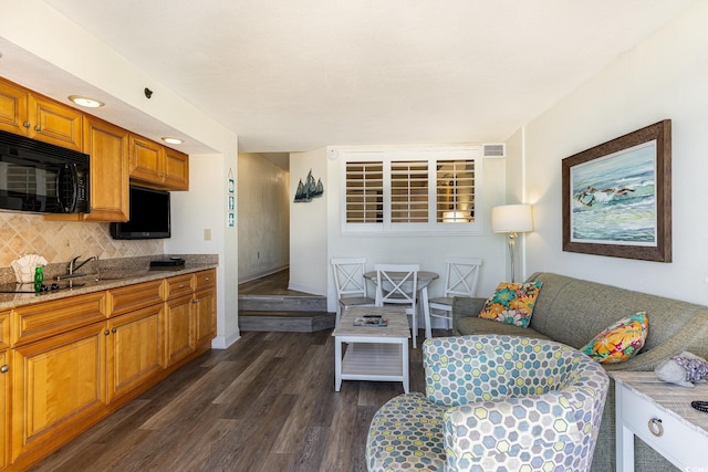 living room with dark hardwood / wood-style flooring and sink