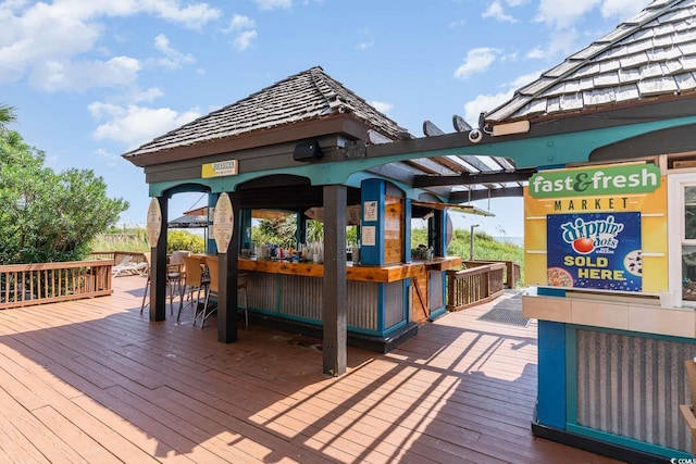 wooden terrace with a gazebo and an outdoor bar