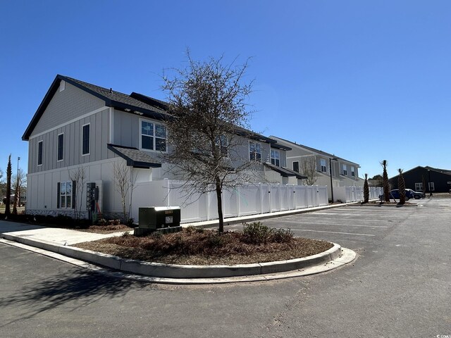 821 Maxine Ct Unit 2C, Myrtle Beach, SC 29577 - exterior space with fence, roof with shingles, and a residential view
