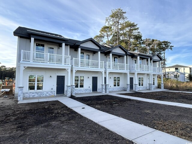 view of front of home with a balcony