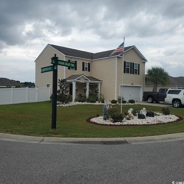 view of front of house featuring a garage and a front yard