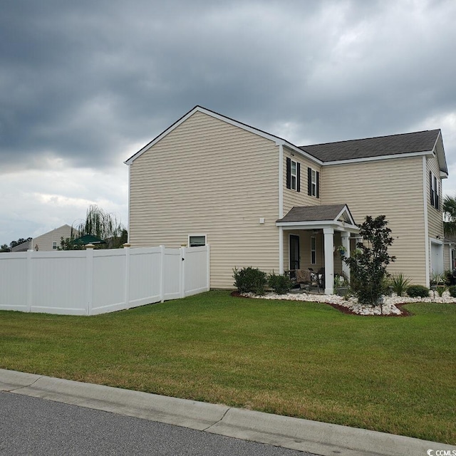 view of side of property with a lawn