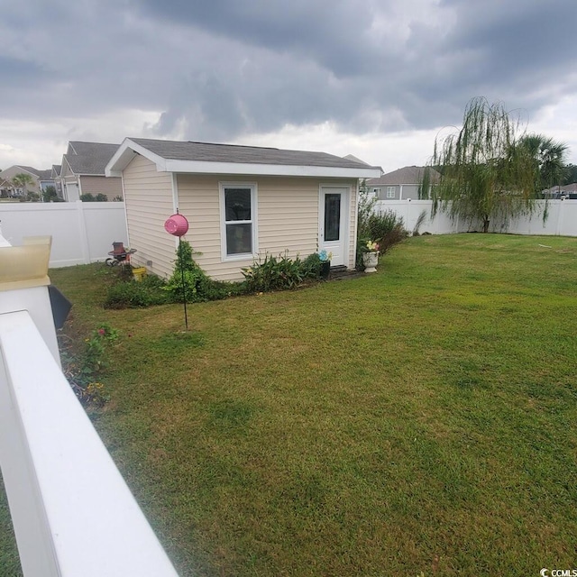 view of side of home featuring a lawn