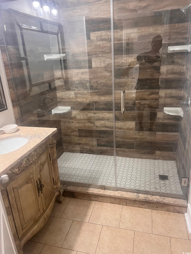 bathroom featuring walk in shower, vanity, and tile patterned floors