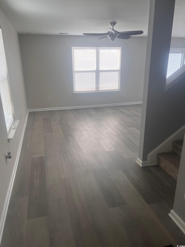 empty room featuring dark hardwood / wood-style floors and ceiling fan