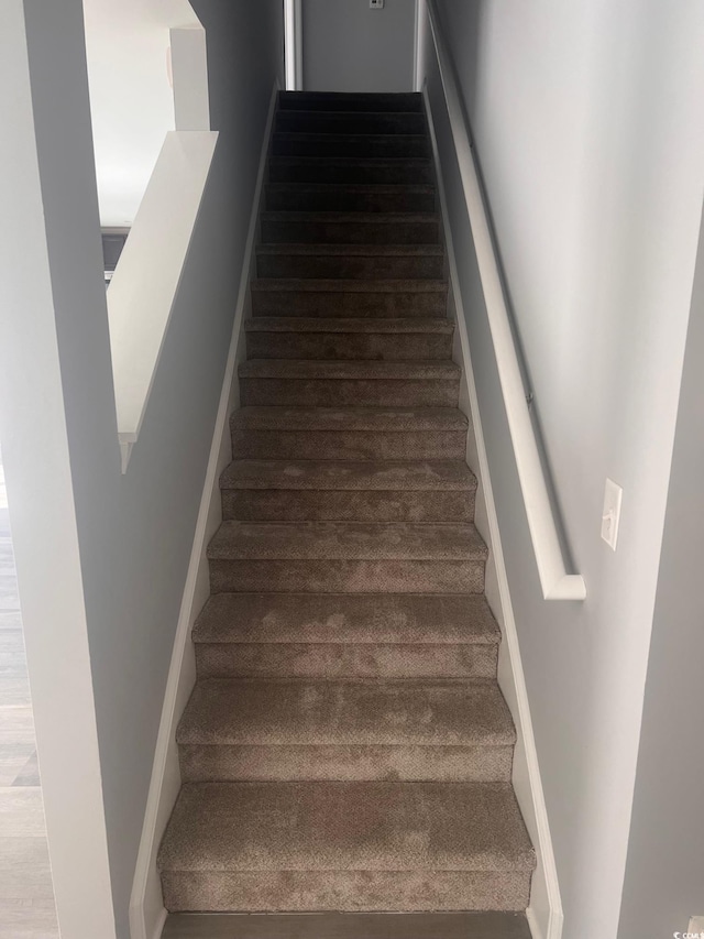 stairs with hardwood / wood-style floors