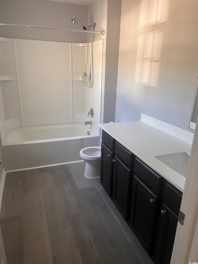 full bathroom featuring hardwood / wood-style floors, vanity, toilet, and shower / bathing tub combination