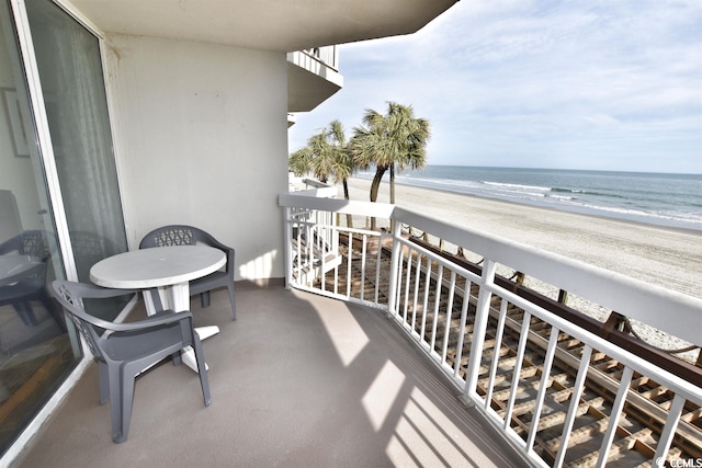 balcony featuring a water view and a view of the beach