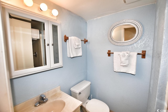 bathroom featuring toilet and sink