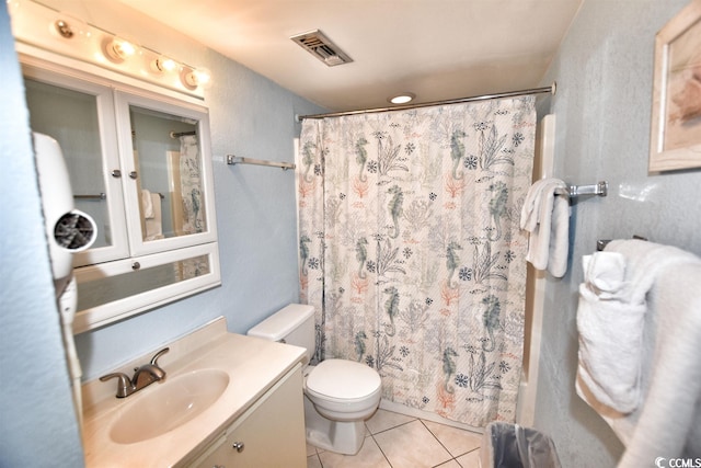 bathroom featuring tile flooring, oversized vanity, and toilet