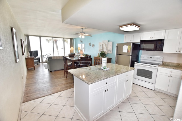 kitchen featuring electric stove, stainless steel fridge, ceiling fan, light hardwood / wood-style flooring, and white cabinetry