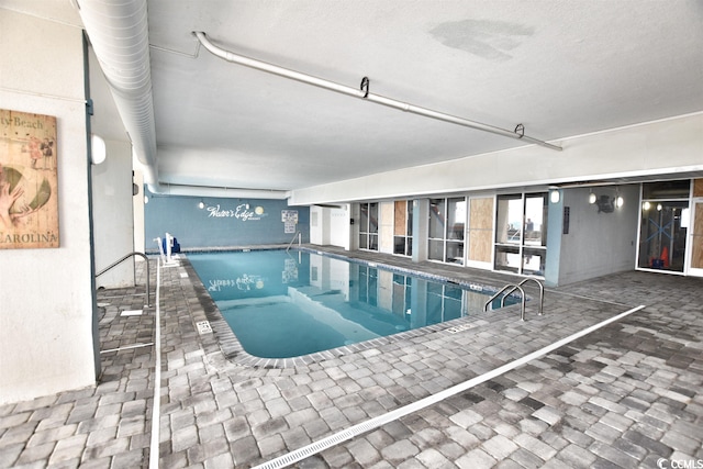 view of swimming pool featuring a hot tub