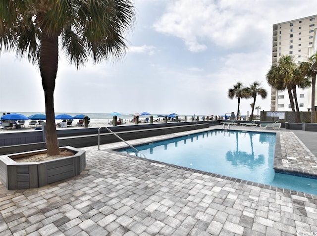 view of swimming pool with a patio