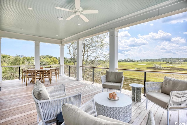 sunroom with plenty of natural light and ceiling fan