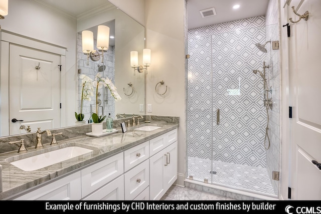 bathroom with dual sinks, ornamental molding, large vanity, and a shower with door