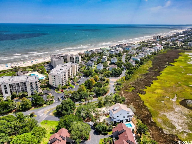 drone / aerial view featuring a water view and a view of the beach