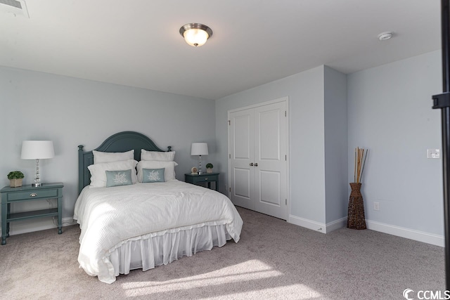 carpeted bedroom with baseboards and visible vents