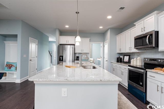 kitchen with white cabinetry, decorative backsplash, stainless steel appliances, and a sink