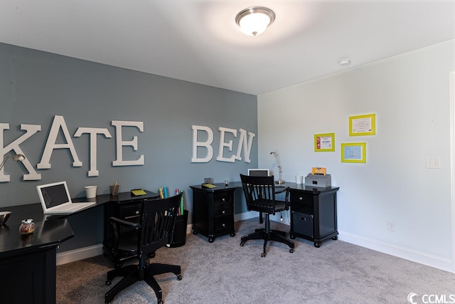 carpeted office space featuring baseboards