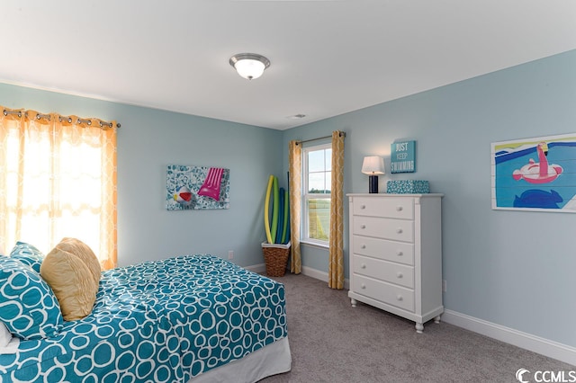 bedroom featuring carpet floors, visible vents, and baseboards