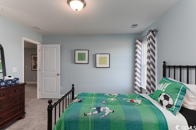 carpeted bedroom featuring visible vents