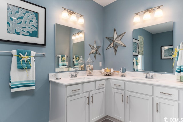 full bathroom with double vanity and a sink