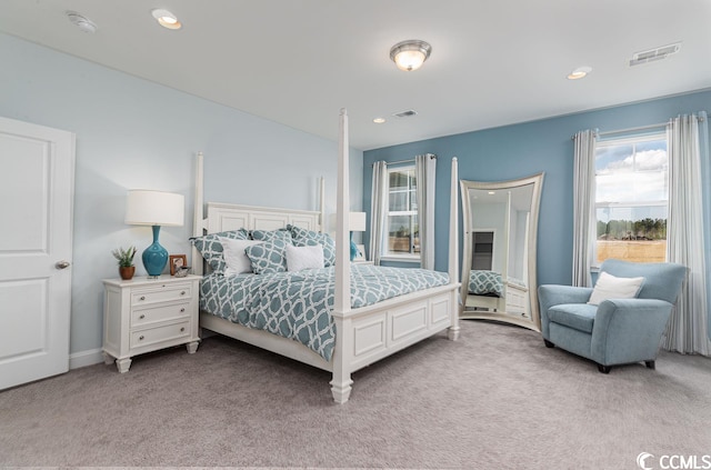 bedroom featuring light carpet, visible vents, and recessed lighting